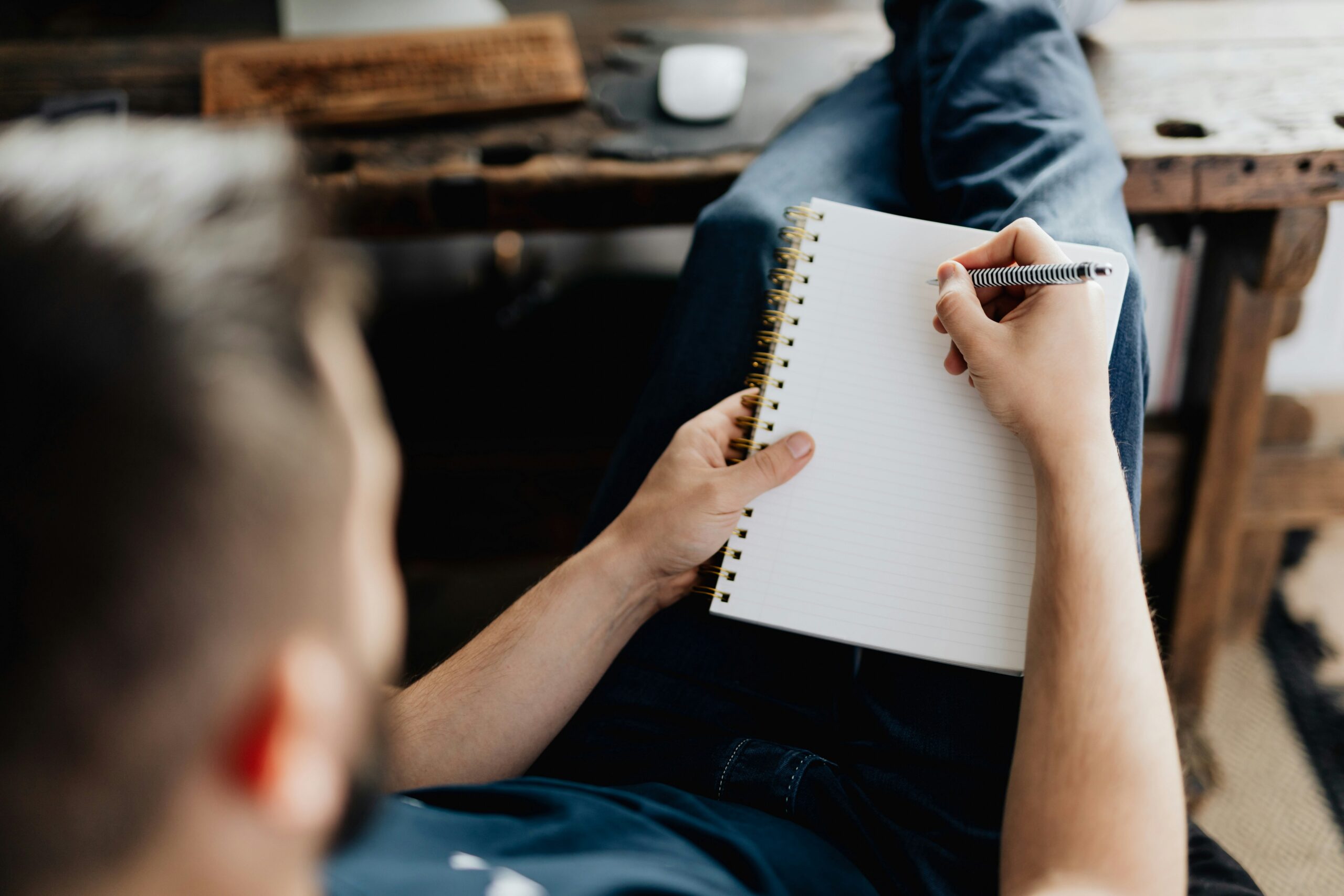 A Man holding a notebook, symbolising the desire for creative writing.